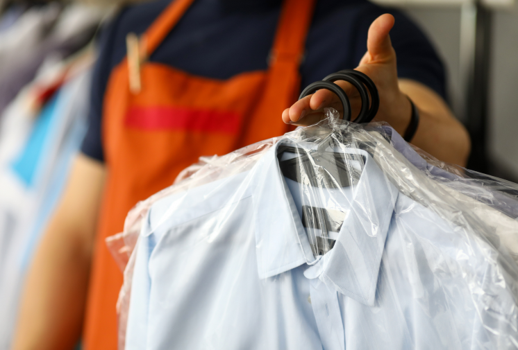 Clothes-dry-cleaning-service-worker-returning-shirts-customer